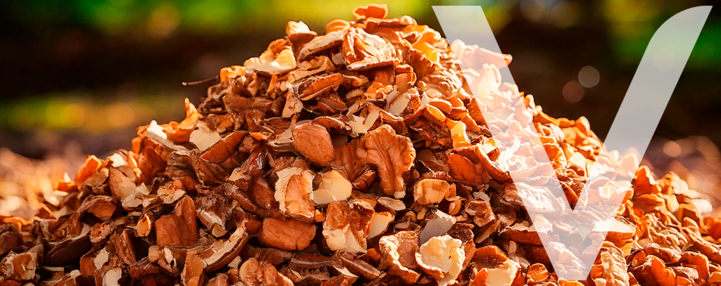 Crushed walnut shells used as biomass for renewable energy production or organic composting.